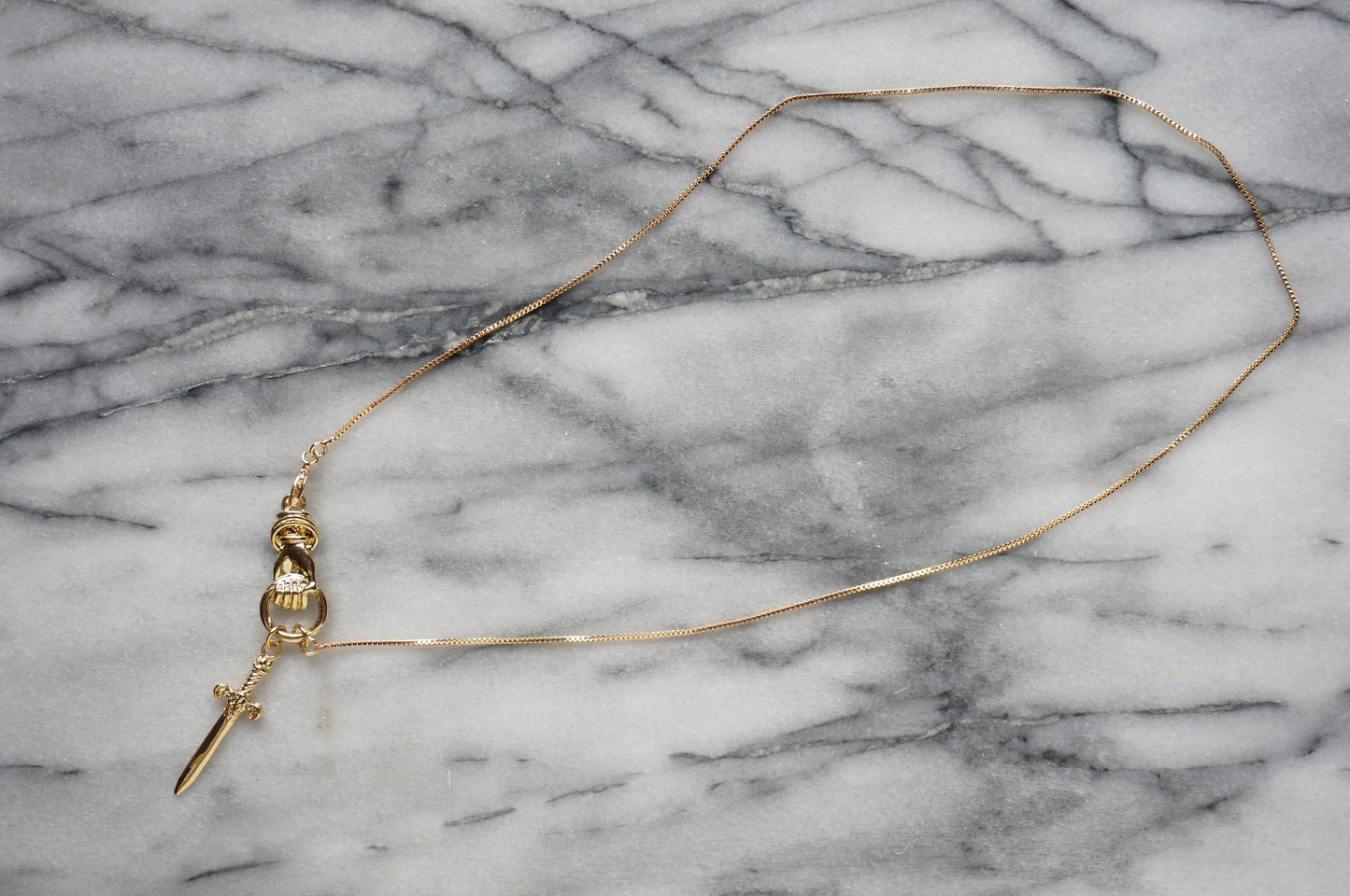 THE HAND Gold / Silver / Black hand and sword necklace / Gold / Silver / Black sword statement necklace