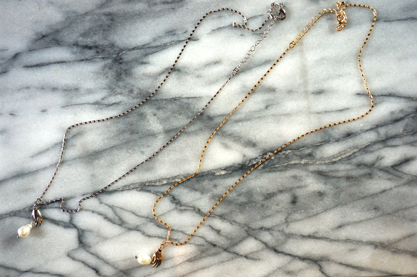 Hand holding pearl-drop necklace / Teardrop Pearl and hands dainty necklace