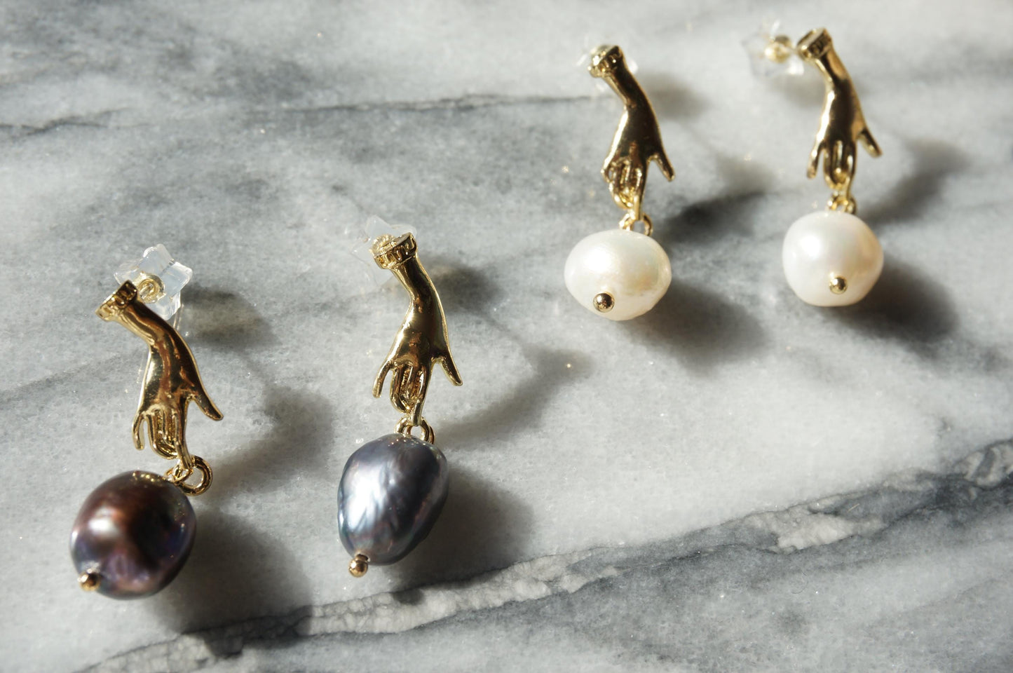 HAND HOLDING baroque Pearl 18k gold plated STUD earrings / white and black pearl earrings