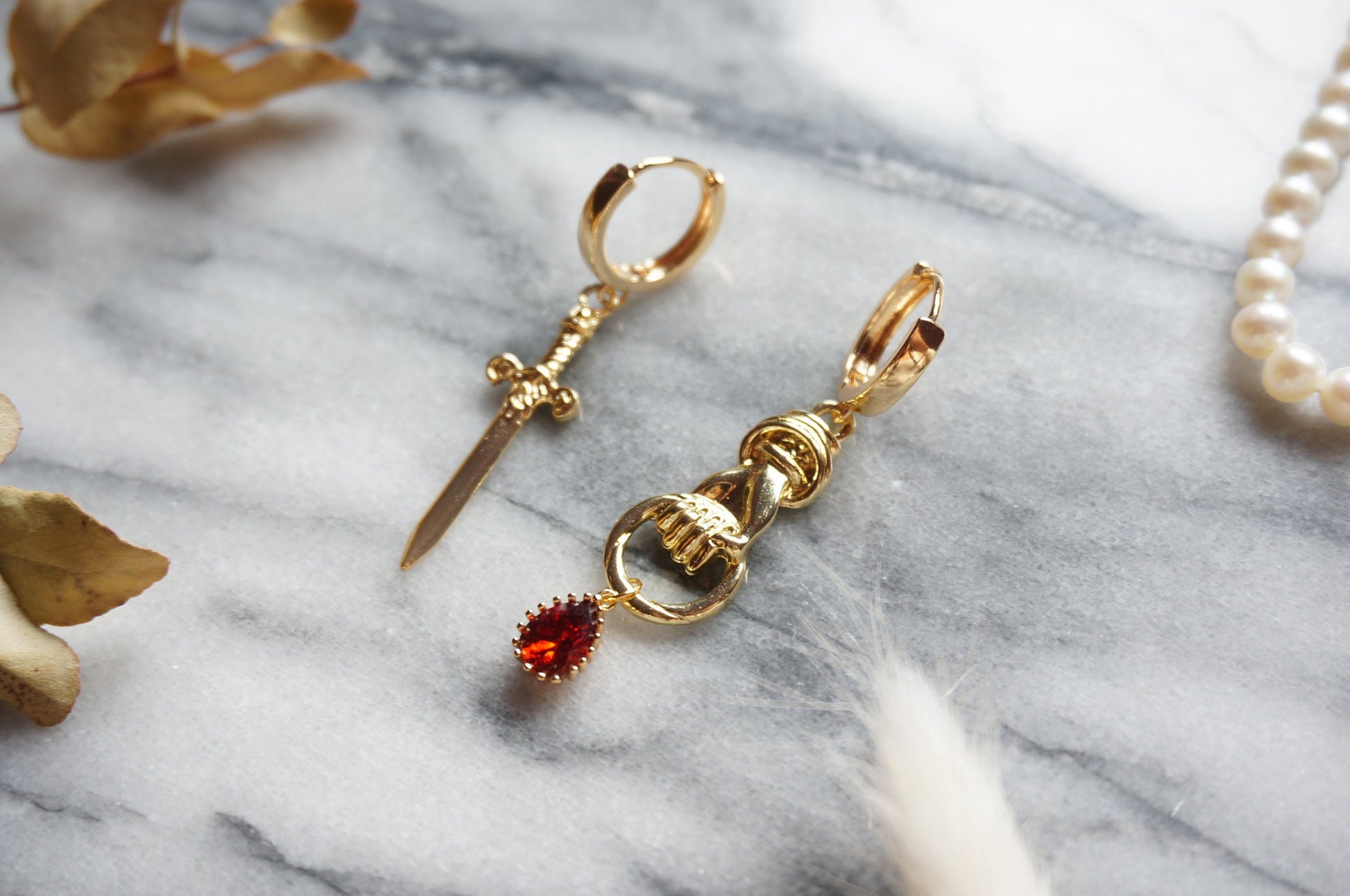 THE HAND Gold Sword and Teardrop Mismatched Huggie Earrings / Red Teardrop Earrings
