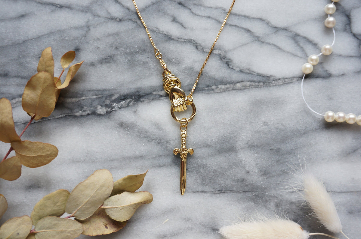 THE HAND Hand Holding Sword Necklace: Gold, Silver, Black Plated Brass Statement Pendant