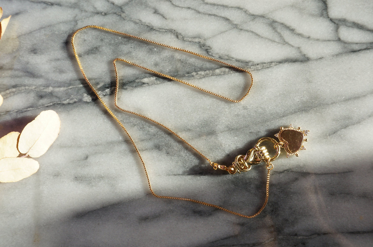 Hand holding Heart Gold / Silver Necklace