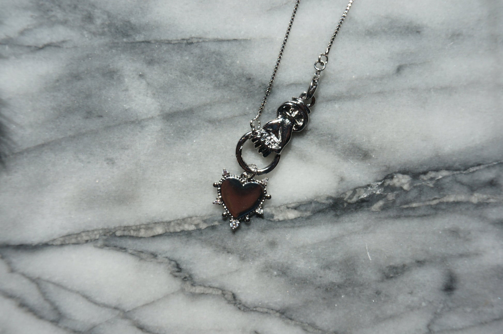 Hand holding Heart Gold / Silver Necklace