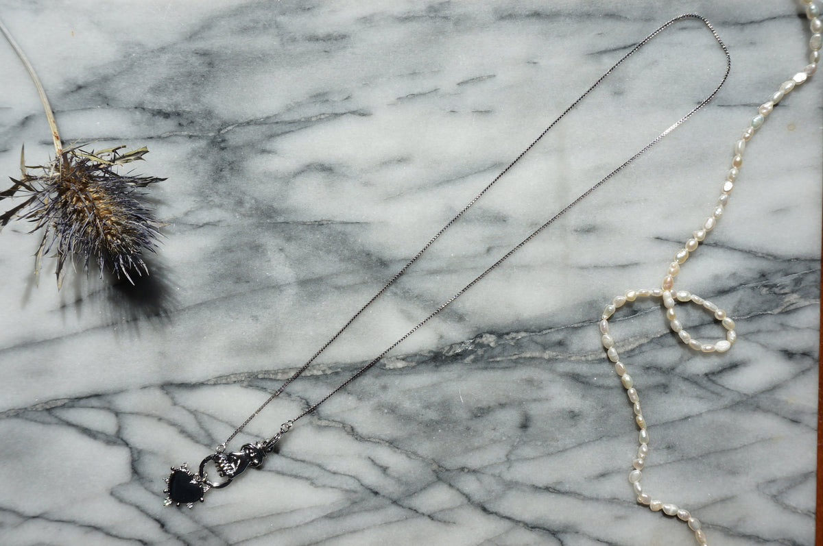 Hand holding Heart Gold / Silver Necklace