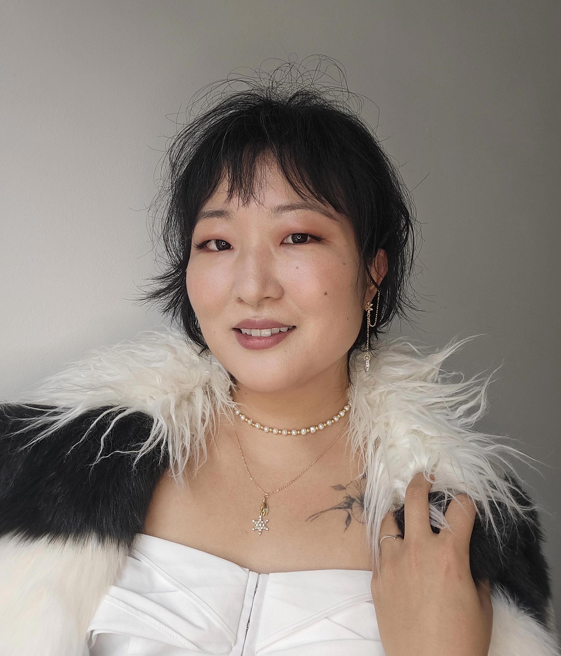 NEVE Gold Plated Hand Holding Snowflake Necklace