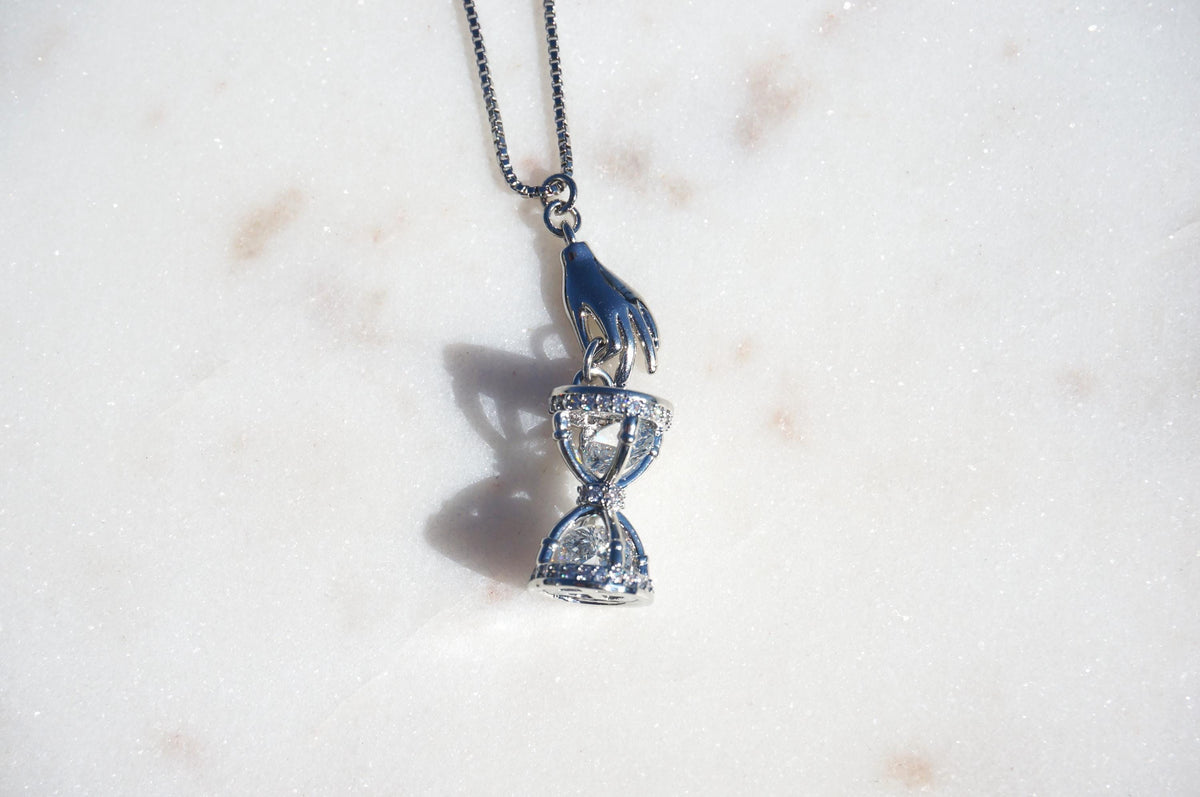 Gold/Silver Hand Holding Hourglass Necklace