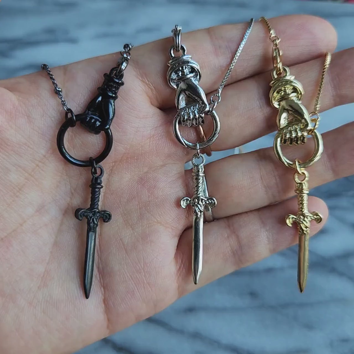 THE HAND Hand Holding Sword Necklace: Gold, Silver, Black Plated Brass Statement Pendant